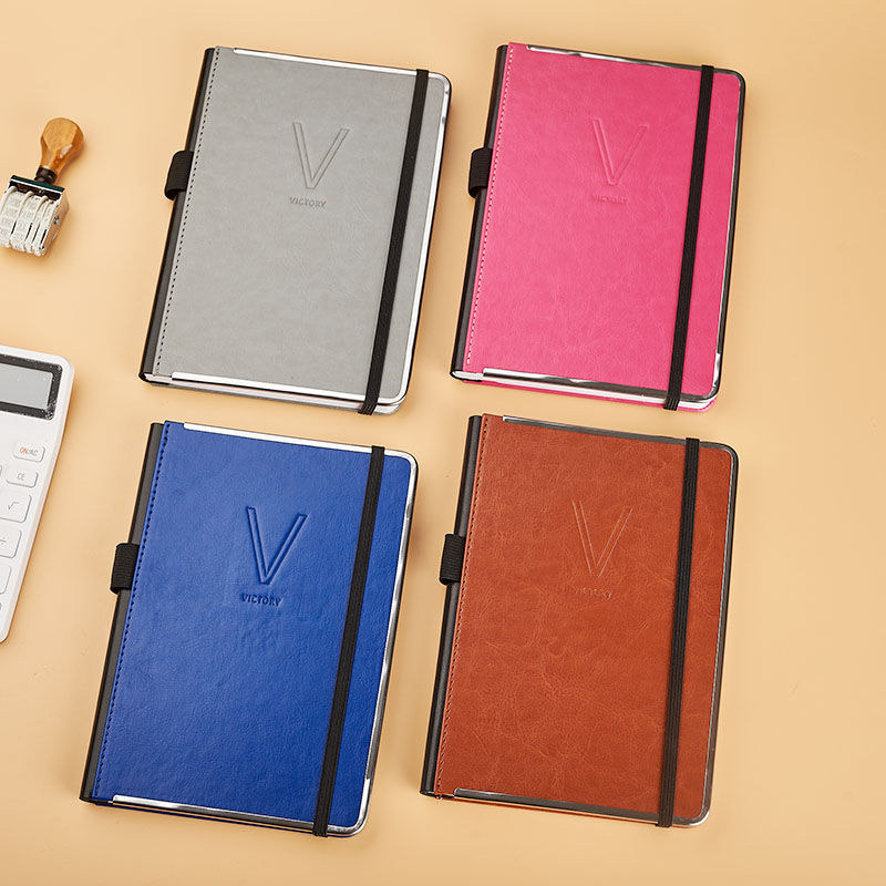A5 pu with another pu on spine stitched diary.agendar with elastic band  and tri-side metal frame D 39040